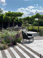 Drought Tolerant Cambridgeshire Garden

Large unit porcelain paving, Belgian bricks, grey and pastel informal planting.