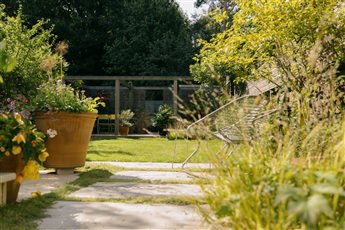 Family garden with limestone paving and pergola.