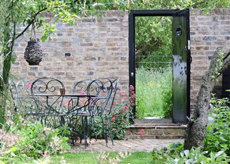 little dell garden with open door