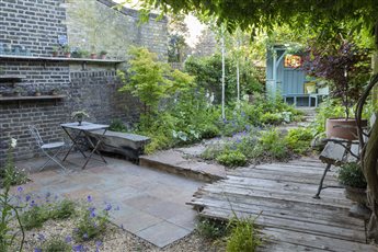 A small urban retreat  that picked up 4 National BALI Awards.  Environmentally sound by keeping as much on site as possible and sourcing used and reclaimed items throughout.  Relaxed planting of blue, pink and white pallet.