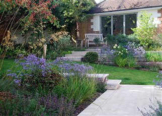 sloped contemporary garden with studio