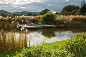 The view over the pond embraces the South Downs beyond, the deck providing the perfect destination to enjoy views back to the house