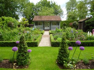 Complete transformation of a large family garden in Bovingdon, Hertfordshire. Image shows cutting garden and summer house. 
Photo credit: Rebecca Bernstein.
https://www.thegardenco.co.uk/residential/a-sense-of-place/