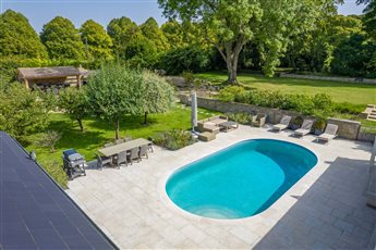 Part of a large garden in Buckinghamshire where a swimming pool leads to a drought tolerant garden with kitchen loggia. The stone wall encloses the pool from the main lawn.

