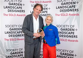 SGLD Awards 2026 Lifetime Achievement Award winner Tom Stuart-Smith OBE FSGLD with gold sponsor Alitex