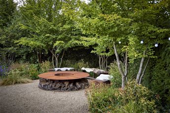 Hestia Garden at The Plough Shiplake in Oxfordshire; view of the communal fire bowl tucked within the Woodland Edge planting scheme. Photograph Alister Thorpe.