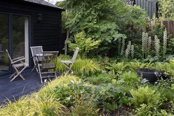 An extensive, sunken porcelain and clay paver dining and entertaining terrace close to the house, includes a barbeque and hot tub area. A black basalt path leads beneath an oak pergola to the games room, wildflower planting and a woodland garden.