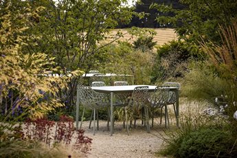 Hestia Garden at The Plough Shiplake in Oxfordshire; the view to a cornfield in the landscape is echoed by golden-toned ornamental grasses within the garden. Photograph Alister Thorpe.