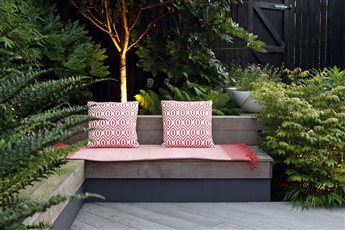 Kings Hill - a blank canvas new build garden into a sleek and special place, balancing tropical plants and flowering perennials with a repeat of ipe hardwood, black basalt and rendered walls in 3 colours. 