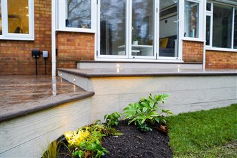 Karl Harrison Landscapes Ltd combined Millboard Enhanced Grain Antique oak with Limed oak to create the ultimate designer contrast. Completing the deck design with Ellumiere garden and deck lights by Country Supplies.  