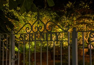 Garden lighting design and installation by Mark Packham, Garden and Landscape Lighting Designer at Garden Spark 
Garden gates entering into garden with gently lit planting 