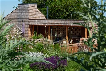 Outdoor kitchen and garden room in Grade 2 listed setting with Mediterranean style planting