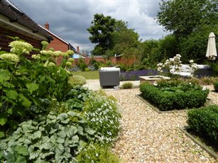 Family garden for entertaining with bespoke firepit