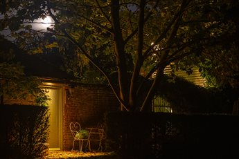 Garden lighting design and installation by Mark Packham, Garden and Landscape Lighting Designer at Garden Spark 
Entrance to small cottage gently illuminated with a single light fixture