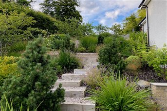 Family garden in Rhu. We have created terraces and staggered steps to create ease of access, flow and interest throughout the garden. 