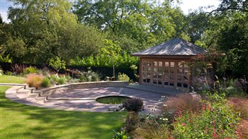 Beautifully inviting summer house transformed a difficult downwardly sloping garden into an inviting retreat.  The rill uses the slope to advantage.