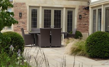 Planting, paving and furniture in harmony.  Plants to soften the edges, paving to define the intimate space and the right furniture to allow both dining and relaxation.