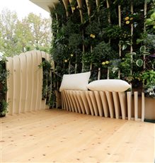 A small balcony with a garden added over the existing structure. The components were designed to be brought through the building and apartment. Integral seating with vertical planting which includes herbs, evergreens and scented species.
