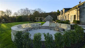 Rural garden design for a Yorkshire farmhouse on Ilkley Moor incorporating a stone Firepit circle, large bespoke oak pergola and Yorkstone paving. 