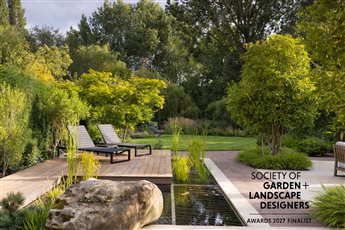 This elegant garden has been thoughtfully designed to create a sense of calm, space, and understated luxury. Backing onto a river, it makes the most of its unique setting. Natural materials are used throughout, complemented by soft planting.