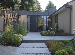 A contemporary front garden to complement the modern architectural features on the clients' house. A stepping stone path leads to the front door and planting has been used to distinguish the pedestrian access from the drive.