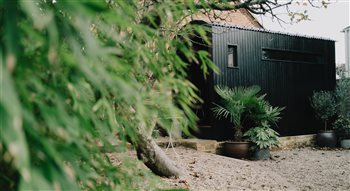 Wildhut luxury 8 person outdoor sauna with open porch and integrated shower in Brighton home . 