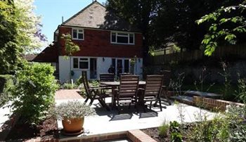 Generous planting and a series of patios in a vernacular garden site.