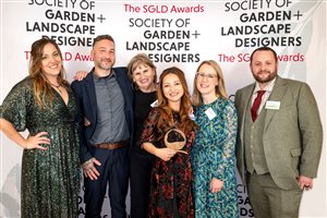 SGLD Awards 2026 Grand Award winner Charlotte Rowe Garden Design, Principal Designer Tomoko Kawauchi MSGLD with sponsor Ca'Pietra