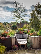 Behind the paved area will be three deep stepped curved planters, bespoke manufactured in GRP fibreglass. The planters will benefit from a bespoke water feature comprising stainless steel water blades in the front edge of each planter.