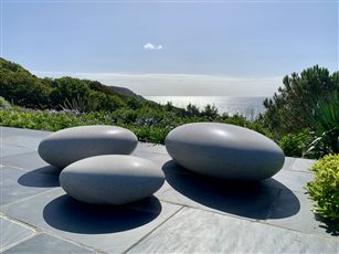 Polished concrete pebble seats by Ben Barrell on the terrace on this Cornish coastal project