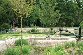 Spiralling walls act as entrance gates with Acer campestre.