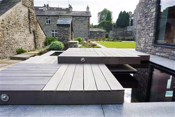 An architect designed house needed a contemporary garden that allows the house owner to view the distant hills. A reflective water feature breaks up the space and adds a dynamic element to the garden.