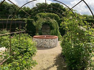 Reclaimed brick and flint water feature in the Kitchen Garden at a project in Froxfield, Hampshire