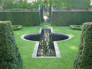 View across reflective water feature to the parkland.