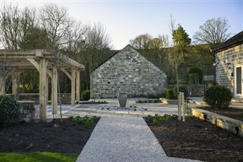 Garden design for a rural Yorkshire farmhouse on Ilkley Moor, incorporating a bubbling urn waterfeature, large bespoke oak pergola for entertaining. 