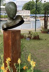 'The Wish' is a bronze head and shoulders on a Corten steel plinth. It is a limited edition bronze of only 9. Each piece is hand made to order and stands at about 1.6m tall. Shown here at The Henley Festival.