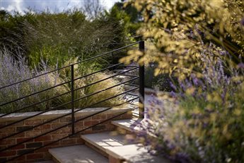 Hestia Garden at The Plough Shiplake in Oxfordshire; view of Mediterranean planting alongside limestone steps and pathway. Photograph Alister Thorpe.