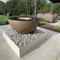 The Specular with an aged bronze bowl and central sculpture, shown with an above-ground reservoir and powder-coated side cladding. The cladding provides another way to integrate the water sculpture into a garden design.