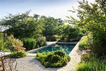 This lovely swimming pool and 5 acre garden in Hampshire was designed by us for client's old farmhouse.  The objective was to ensure that the pool fitted really well into the surrounding landscape which was sloping and rural.