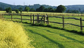 Post and rail fence at the garden boundary at Nursted Barns