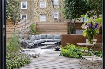 The North London garden design aims to unify the main area of the garden in a single level. The space was divided into sections made up variously of decking, paving and planting beds. 