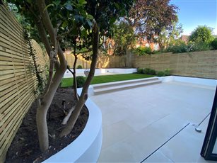 The large porcelain lowers terrace gives a clean and stylish effect...this garden has simple clean lines ...perfect for the contemporary look.