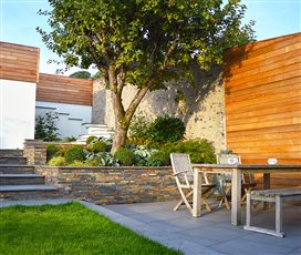 A steeply sloping Devon garden required winding steps to create comfortable access. The rustic brick boundary wall was enhanced with cedar cladding. A characterful mature apple tree was retained and enhanced with shade planting.