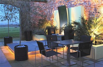 This contemporary garden was created out of a 18th Century Georgian courtyard. Complete with stainless steel waterfeature, and dramatic garden lighting.