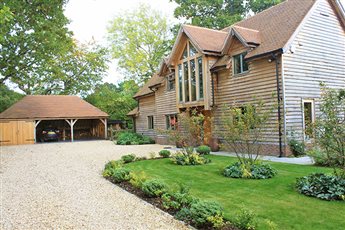 Classically elegant gardens for newly-built timber-framed barn in National Park. Elements include a large circular lawn with block-paver paths, bespoke pergola walkways with scented climbers, generous and classically elegant planting beds.