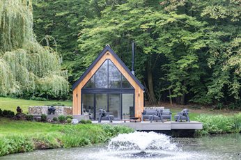 Garden Design and Build by Cube 1994, bespoke garden room with cantilevered decking sitting over natural pond 