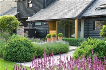 Modern Barn Conversion Garden

Split Level terraces in sandstone and redbrick, Lawn, formal trees and perennial planting. 