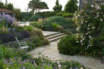 Exhuberant planting embraces the house and terraces in this Guernsey garden