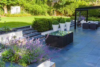 A large entertaining space was created around this new house in Prestbury, with plenty of space for barbecuing and dining for family and friends.