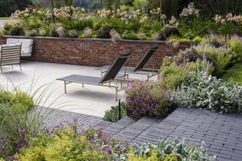 An extensive, sunken porcelain and clay paver dining and entertaining terrace close to the house, includes a barbeque and hot tub area. A black basalt path leads beneath an oak pergola to the games room, wildflower planting and a woodland garden.